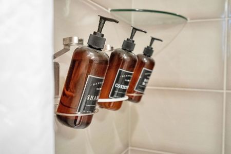Refillable, eco-friendly bath essentials—shampoo, conditioner, and body wash provided for a refreshing stay.