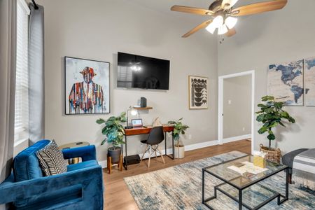 Dedicated workspace w/ a desk, wall-mounted TV & lounge chair — work & relax.