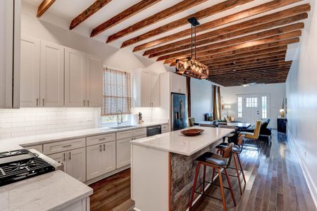 Sun-kissed kitchen w/ warm tones, open layout & everything you need to cook together.