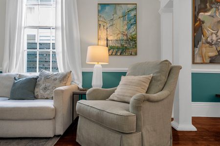 Cozy reading nook w/ a plush chair & soft natural light — perfect for quiet mornings.