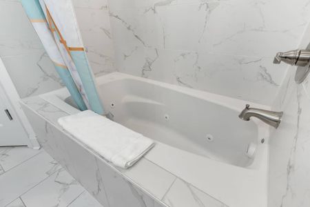Soak and unwind in the bathtub found in the ensuite bathroom.