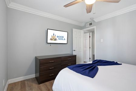 Peaceful bedroom w/ dark wood furniture & soft, soothing tones.