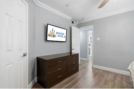 Cozy sleeping space w/ soft bedding & a wall-mounted TV for movie nights.