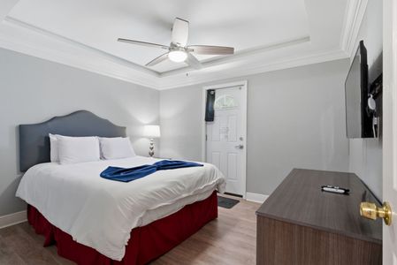 Clean, calm sleeping space w/ ceiling fan & plenty of natural light.