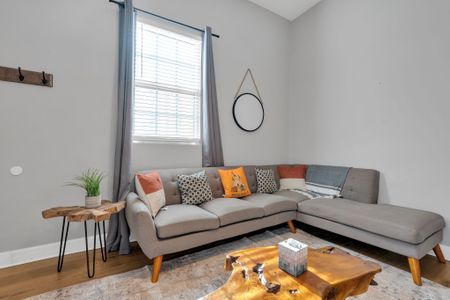 Bright living room w/ a sectional sofa & warm accents — a welcoming space to relax together.