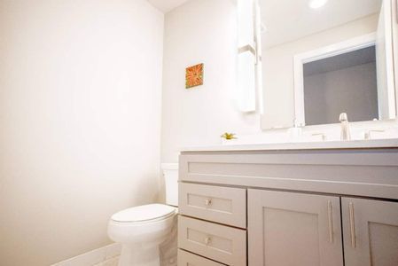 Clean half bath w/ vanity & sink — functional & fresh.