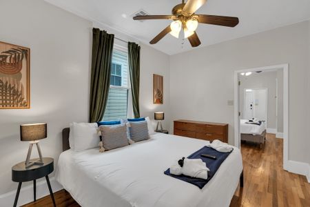 Comfortable bedroom w/ warm wood tones & soft natural light.