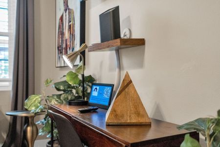 Dedicated work-from-home setup w/ a laptop-ready desk & natural light.