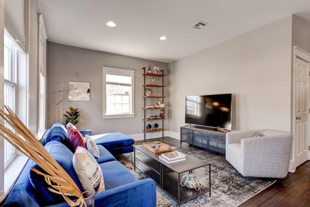 Comfortable living room w/ TV — settle in for a laid-back movie night.