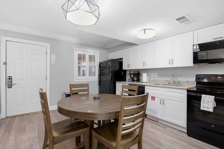 Spacious kitchen w/ ample counter space, cabinetry & a dining nook.