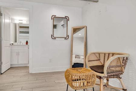 Warm corner w/ a full-length mirror & natural textures — a cozy finishing touch.
