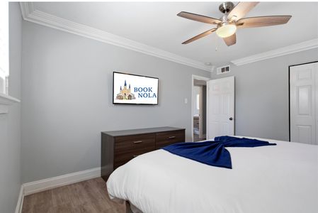 Cozy bedroom nook w/ a bed & wall-mounted TV for relaxed evenings.