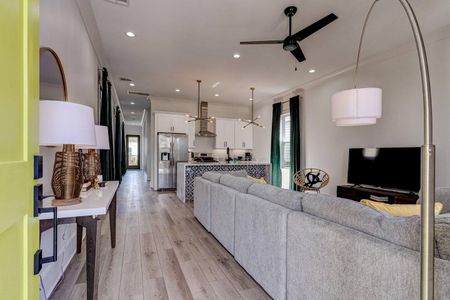 Open-concept living & kitchen w/ light wood floors & a bright, airy feel.