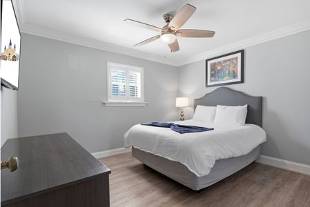 Calm bedroom w/ a plush bed & soft tones for restful nights.