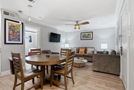 Gather around the dining table in this open, airy living area made for easy meals together.