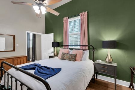 Restful bedroom w/ green accent walls & soft bedding for a good night's sleep.