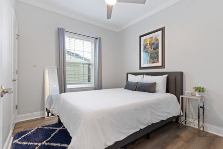 Third bedroom w/ queen bed & local NOLA art adding character to the space.