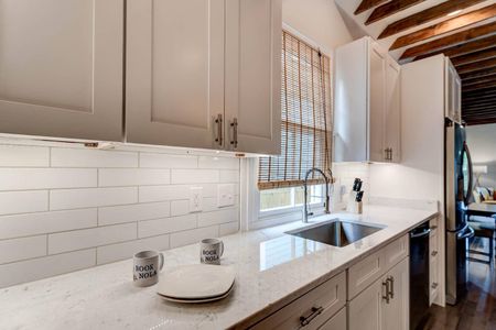 Bright kitchen w/ a deep sink & classic subway tile backsplash.