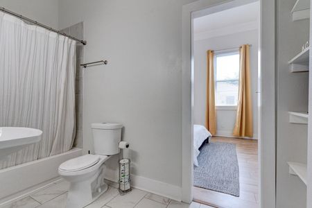 Clean, well-lit bathroom w/ tub & all the essentials you need.