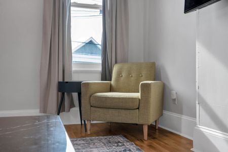 Cozy sitting area w/ a cushioned armchair — a quiet corner to unwind.