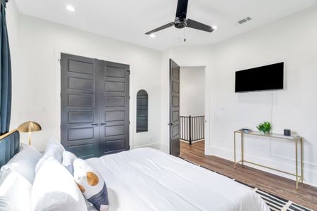 Upstairs king bedroom w/ en-suite bath & bold dark door for a moody, stylish feel.