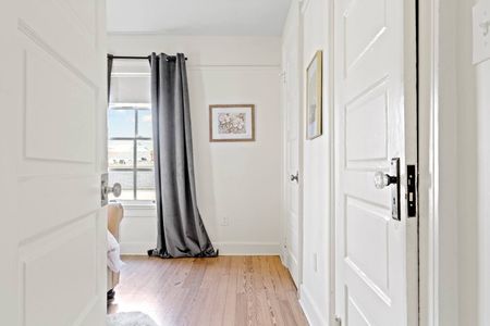 Bright bedroom w/ curtains & natural light.