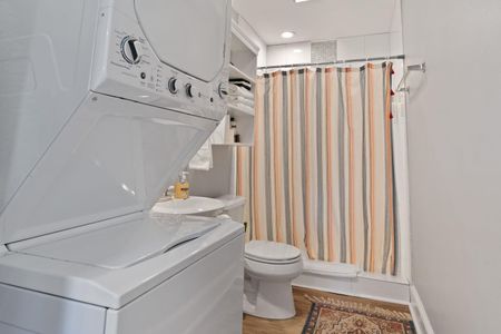 First floor bathroom w/ washer & dryer conveniently tucked in.