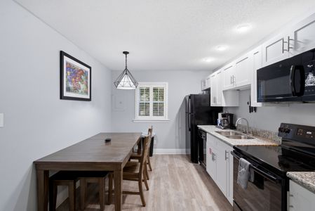 Dining space tucked beside the kitchen for easy casual meals.