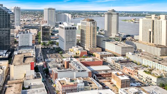 Wake up to sweeping aerial views of a vibrant, walkable city neighborhood.