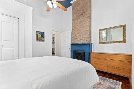 Cozy bedroom corner w/ a fireplace & soft textures for a warm, restful feel.