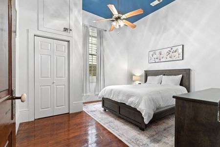 Bright, airy bedroom w/ warm wood floors & plenty of natural light to wake up refreshed.