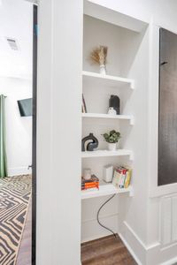 Stylish hallway nook w/ built-in shelves — a charming little detail.