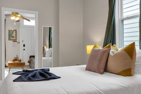 Bright, clean bedroom w/ crisp white bedding & soft natural light for a restful stay.