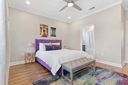 Sunny bedroom w/ a plush bed & warm décor for a cozy, comfortable stay.