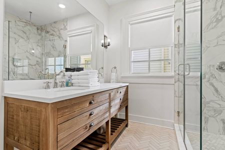 Bright bathroom w/ wood vanity, sink & plenty of counter space.