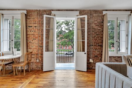 Unwind in the spacious living area adorned with comfortable seating and a flat-screen TV, seamlessly extending to a private balcony where you can enjoy panoramic city views and vibrant sunsets