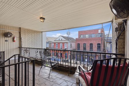 Balcony overlooking a charming streetscape — perfect for morning coffee.
