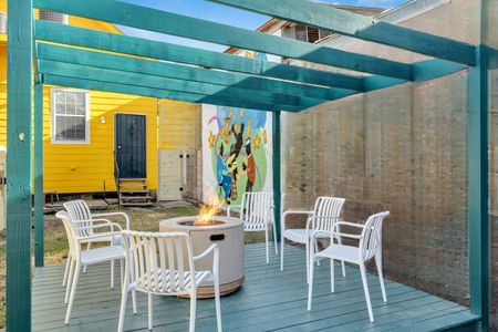Covered courtyard w/ dining seating — a breezy spot for outdoor lounging & meals.