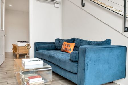 Bold velvet sofa paired w/ a modern acrylic coffee table & cozy touches.