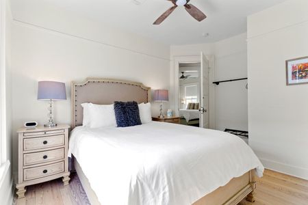 First bedroom w/ storage racks & a cozy bed.