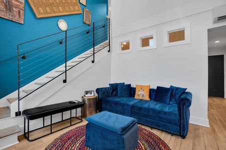 Kick back on blue velvet sofas in a bold, character-filled living room.