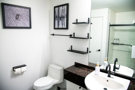 Fresh, well-organized bathroom w/ all the essentials neatly within reach.