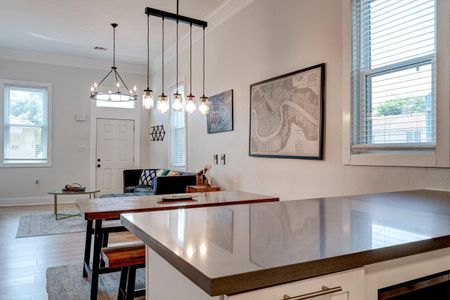 Stylish dining area w/ statement pendant lights & a wood table — a great place to gather.