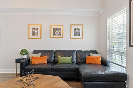 Roomy living area w/ plush sofas & warm accent pillows, perfect for group hangouts.