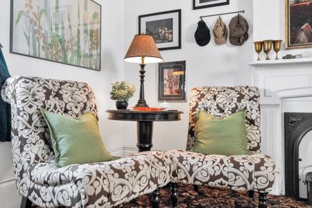 Intimate seating nook w/ lush greenery for quiet moments.