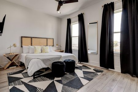 Cozy en suite bedroom w/ large closet & stylish dark curtains.