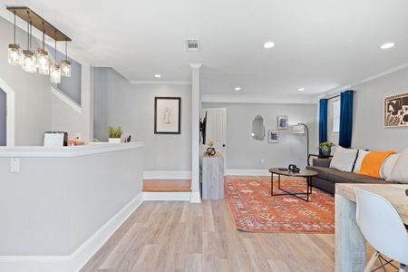 Open living, kitchen & staircase area w/ a bright, connected feel.