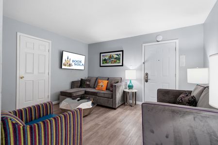 Bright living space w/ bold accent pillows & plenty of comfortable seating.