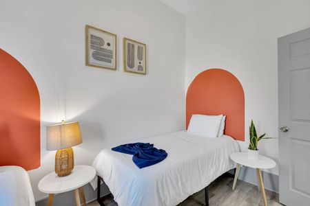 Twin bedroom w/ bold arched headboards & blue accents — fun, modern & full of character.
