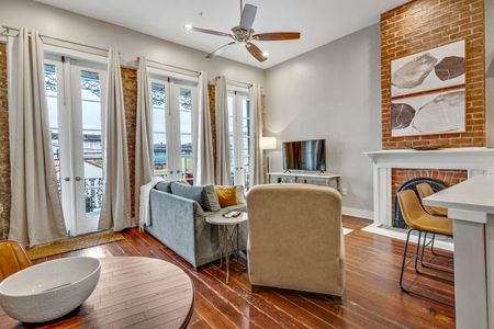 Bright living room w/ large windows & plush seating perfect for unwinding.